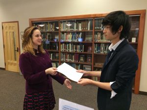 Librarian giving resource to student