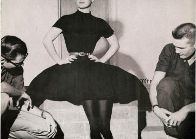 Clothing fads included letter sweaters, blue suede loafers, saddle shoes, and in 1959, long black stockings. In this photo, campus males Dave Shaw (left) and Barry Allen (right) check out Trish Dwelley’s black stockings, usually worn with a black dress.